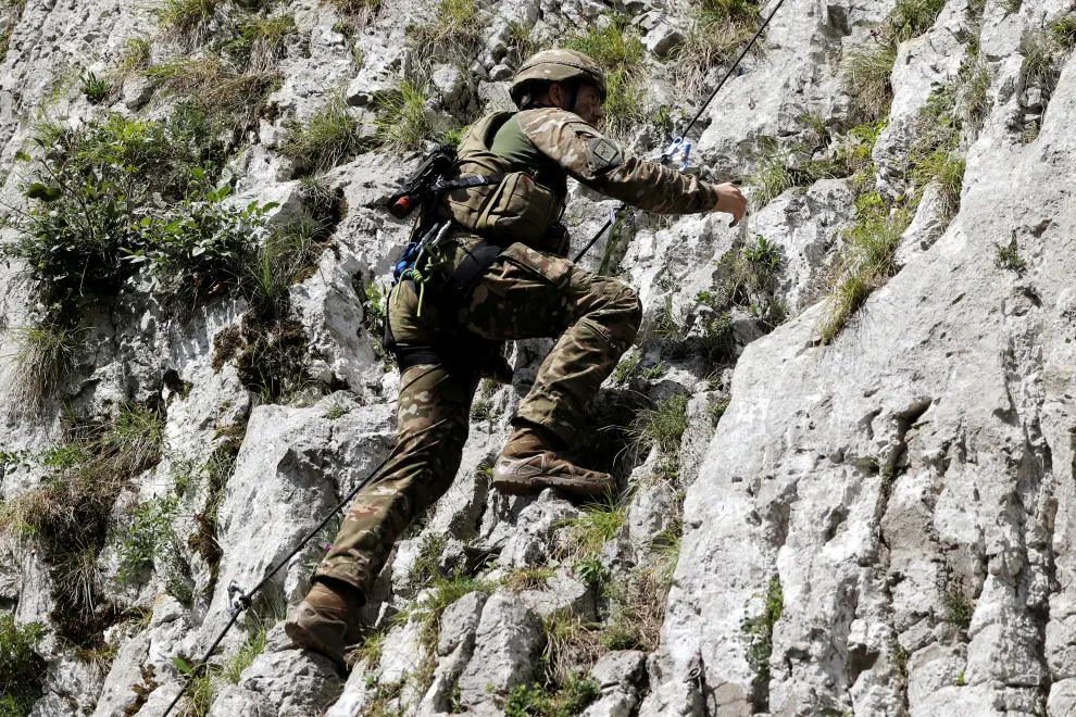 A soldier of the 132nd Mountain Battalion climbing a steep rock as part of regular training. Photo: Daniel Novakovič/STA